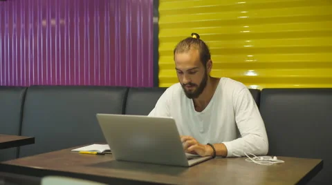 Modern businessman using laptop while sitting in cafe Stock Footage 67095876