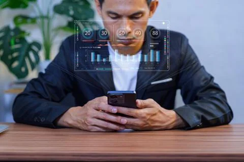 Modern Businessman Using Smartphone with Data Visualization in Office Foto stock