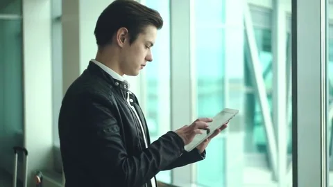 Modern businessman using tablet computer at airport Video stock 69207564