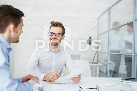 Modern businessmen discussing financial data in paper Stock Photos