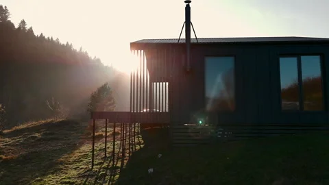 Modern cabin facade with sunlight streaming through slatted panels. Sunlit Stock Footage 293679844