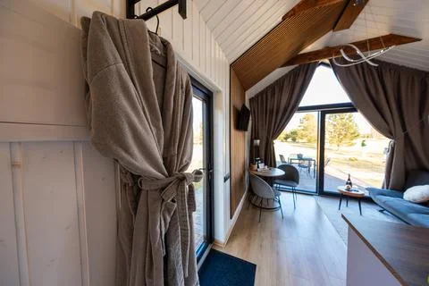 Modern cabin interior with gray robe and antler style light fixture 스톡 사진