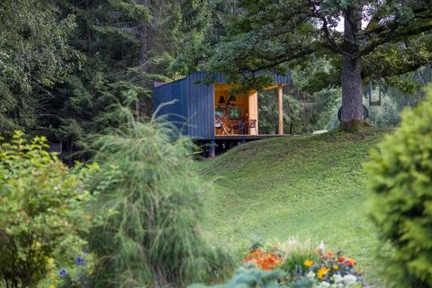 Modern cabin in a tranquil forest setting. Contemporary design blends with na Stock Photos