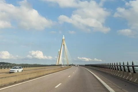 Modern cable-stayed bridge with a distinctive design spanning a highway, ve.. Stock Photos