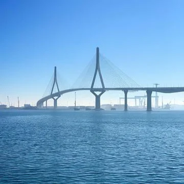 Modern cable-stayed bridge over water with blue sky Stock Photos
