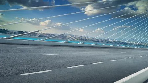 Modern cable-stayed bridge speedway with cityscape .Side angle view . Morning Stock Photos