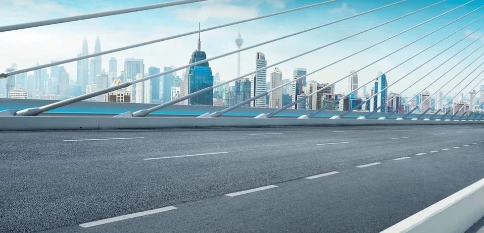 Modern cable-stayed bridge speedway with Kuala Lumpur cityscape .Side angle v Stock Photos