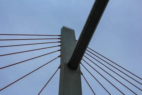 Modern cable-stayed bridge structure against cloudy sky in urban setting Stock Photos