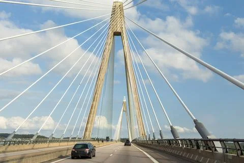 Modern cable-stayed bridge with tall pylons and suspension cables, vehicles.. Stock Photos