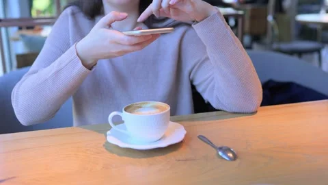 Modern Cafe Experience Sipping on Coffee While Engaging with Your Smartphone Stock Footage 305863663