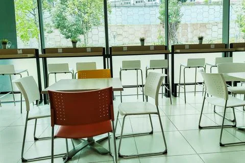 Modern cafe interior featuring stylish seating arrangements, large windows,.. 스톡 사진