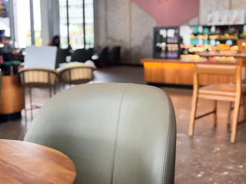 Modern Cafe Interior Selective Focus on Leather Chair and Blurred Background Stock Photos