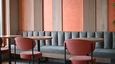 A modern cafe interior shows a cozy space with tables and chairs arranged neatly Stockbeeldmateriaal 336778267