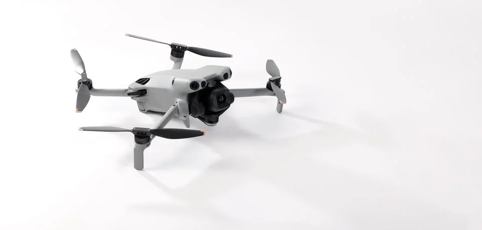 Modern camera drone with remote controller on white background. Stock-Fotos