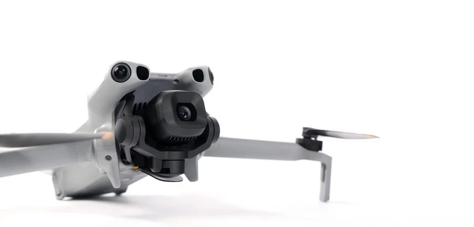 Modern camera drone with remote controller on white background. Stock Photos
