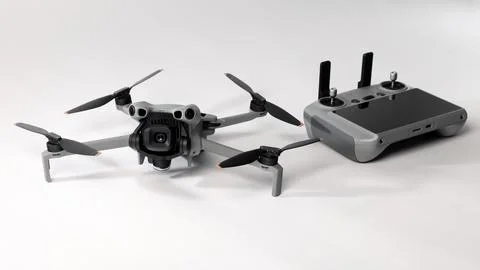 Modern camera drone with remote controller on white background. Stock Photos