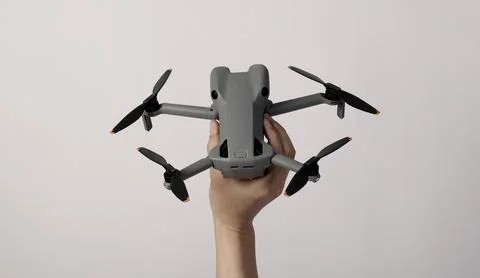 Modern camera drone with remote controller on white background. Stock Photos