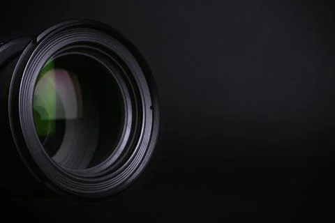 Modern camera lens on black background, closeup. Space for text Stock Photos
