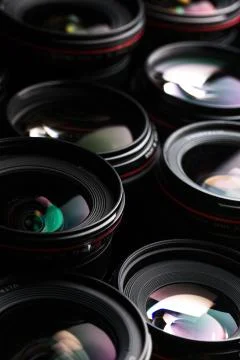 Modern camera lenses with reflections, low key image Stock Photos