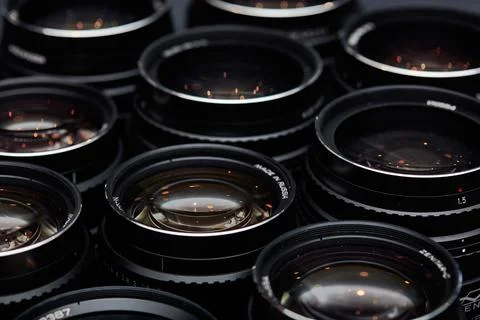 Modern camera lenses with reflections, low key image Stock Photos