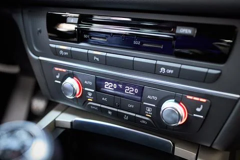 Modern car climate control panel for driver and passenger with shallow depth of Stock Photos