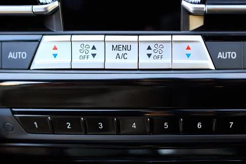 Modern car dashboard features climate control panel with silver buttons for t Fotos de archivo