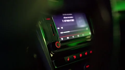 Modern car dashboard multimedia screen playing music at night Stock Footage 343014277