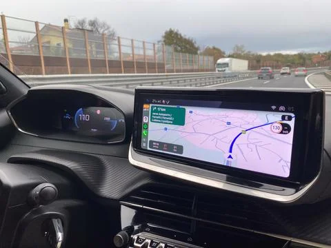 Modern car dashboard with navigation system displaying route on highway Stock Photos