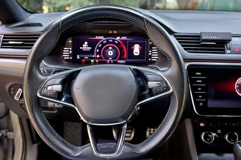 Modern car interior with digital dashboard and steering wheel Stock Photos
