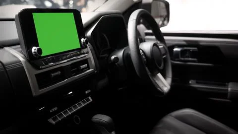 Modern car interior with digital infotainment display green screen mockup. Stock Photos