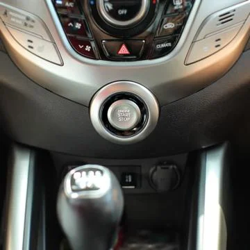 Modern car interior with engine start stop button in focus. Stock Photos