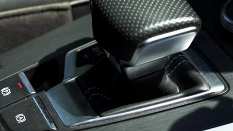 Modern car interior showing automatic gear shifter and control buttons for Stock Footage 347579696