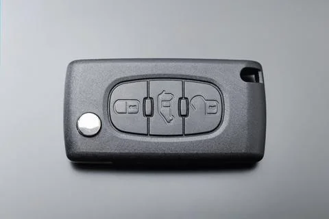 Modern car key with remote control, on black background Stock-Fotos