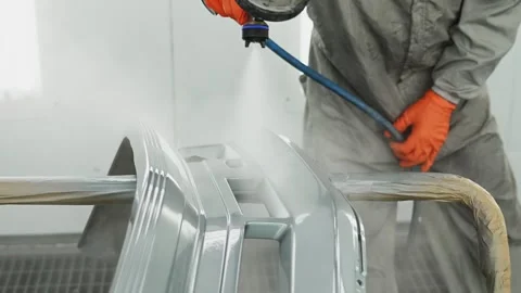 Modern car painting. Man is using spraying machine, holding it in hand, dressed Stock Footage 263156755