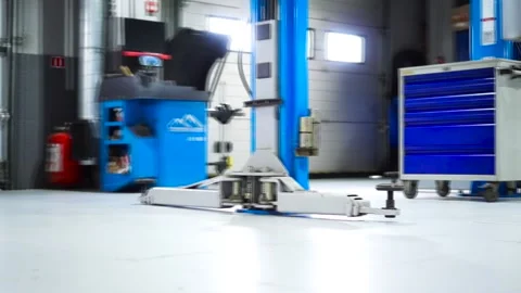 Modern car service inside with machine hydraulic lifts, machine tools and 動画素材 139347953