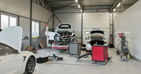 Modern Car Service Workshop With Multiple Cars Under Repair Stock Footage 277297276