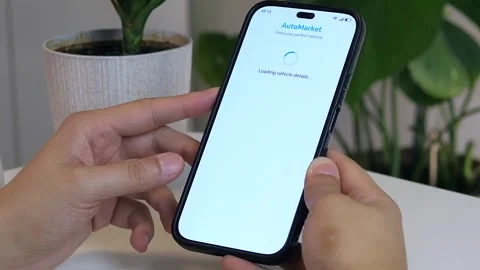 Modern car shopping experience - hands navigate smartphone to research vehicle 스톡 동영상 314890862