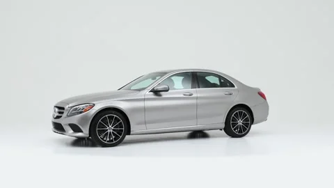 Modern car in studio rotation shot Cirrus White 2019 Mercedes-Benz C-Class C300 Stock Footage 159380780