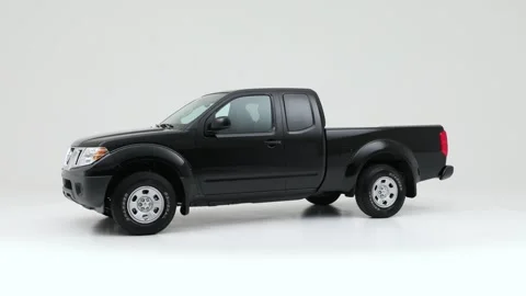 Modern car in studio rotation shot Crystal White Tricoat 2018 Nissan Frontier S Stock Footage 159382009