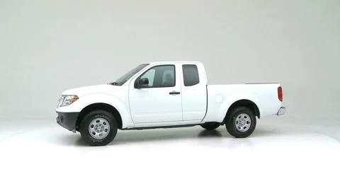 Modern car in studio rotation shot Lunar Silver Metallic 2016 Nissan Frontier S Stock Footage 159388039
