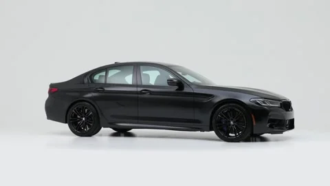 Modern car in studio rotation shot Milano Red 2021 BMW 5-series M5 Stock Footage 159527448