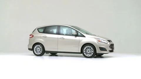 Modern car in studio rotation shot Omaha Orange 2017 Ford C-Max Hybrid SE Stock Footage 159530893