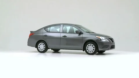 Modern car in studio rotation shot Carmine Red 2016 Nissan Versa S Plus Stock Footage 159534247