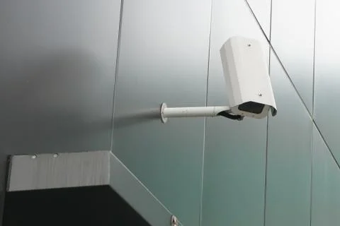 Modern cctv camera attach to the wall. Concept of surveillance and monitoring Stock Photos