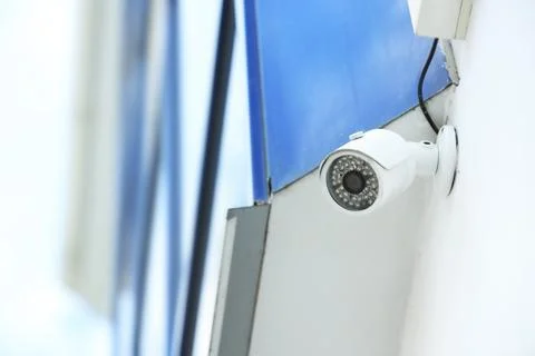 Modern CCTV security camera on building wall outdoors. Space for text Fotos de archivo