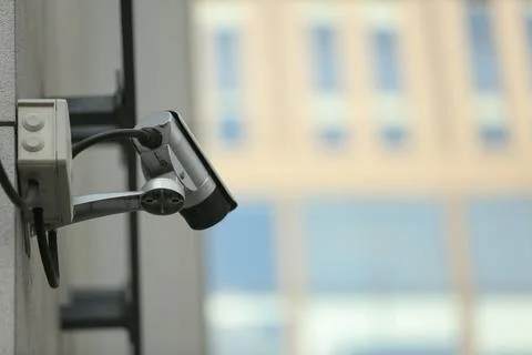Modern CCTV security camera on building wall outdoors. Space for text Fotos de archivo