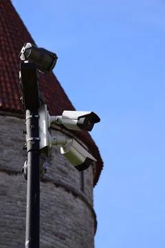 Modern CCTV security cameras on a pole contrasting Stock Photos