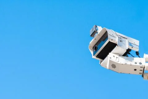 Modern CCTV security system on sky background Smart camera theft protection. Stock Photos