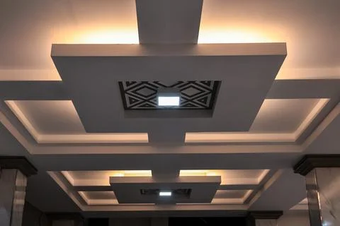 Modern ceiling design with geometric patterns and soft ambient lighting enh.. Stock Photos