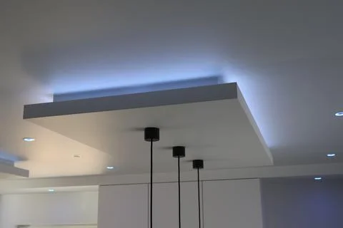 Modern ceiling design with recessed lighting and pendant lights Stock Photos